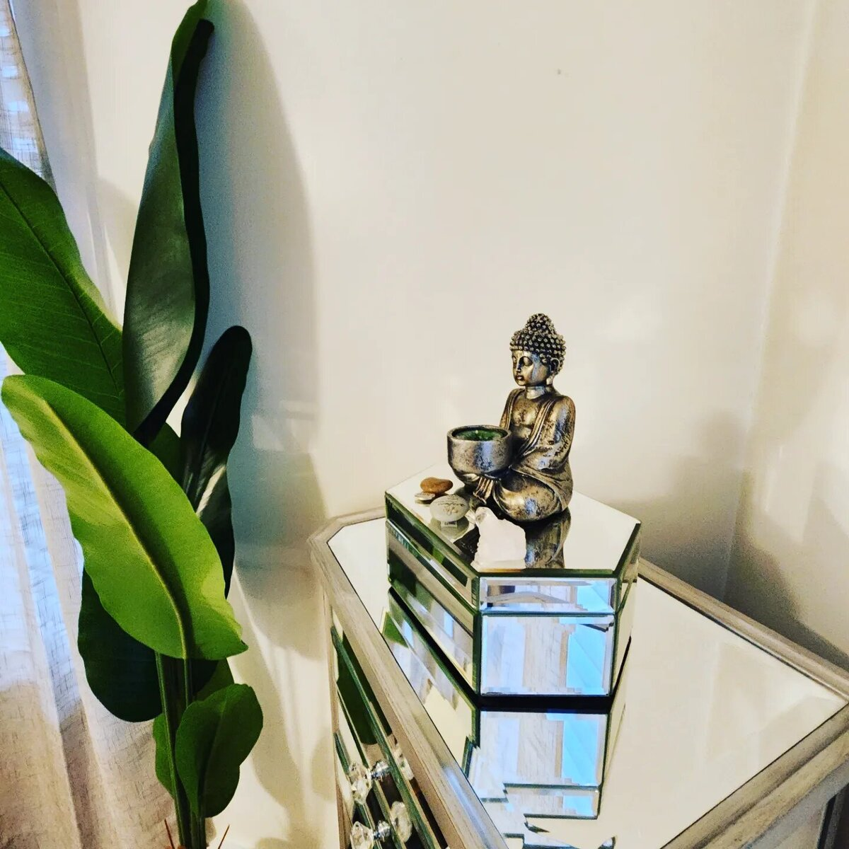 Mindful styling detail with brass buddha and crystals